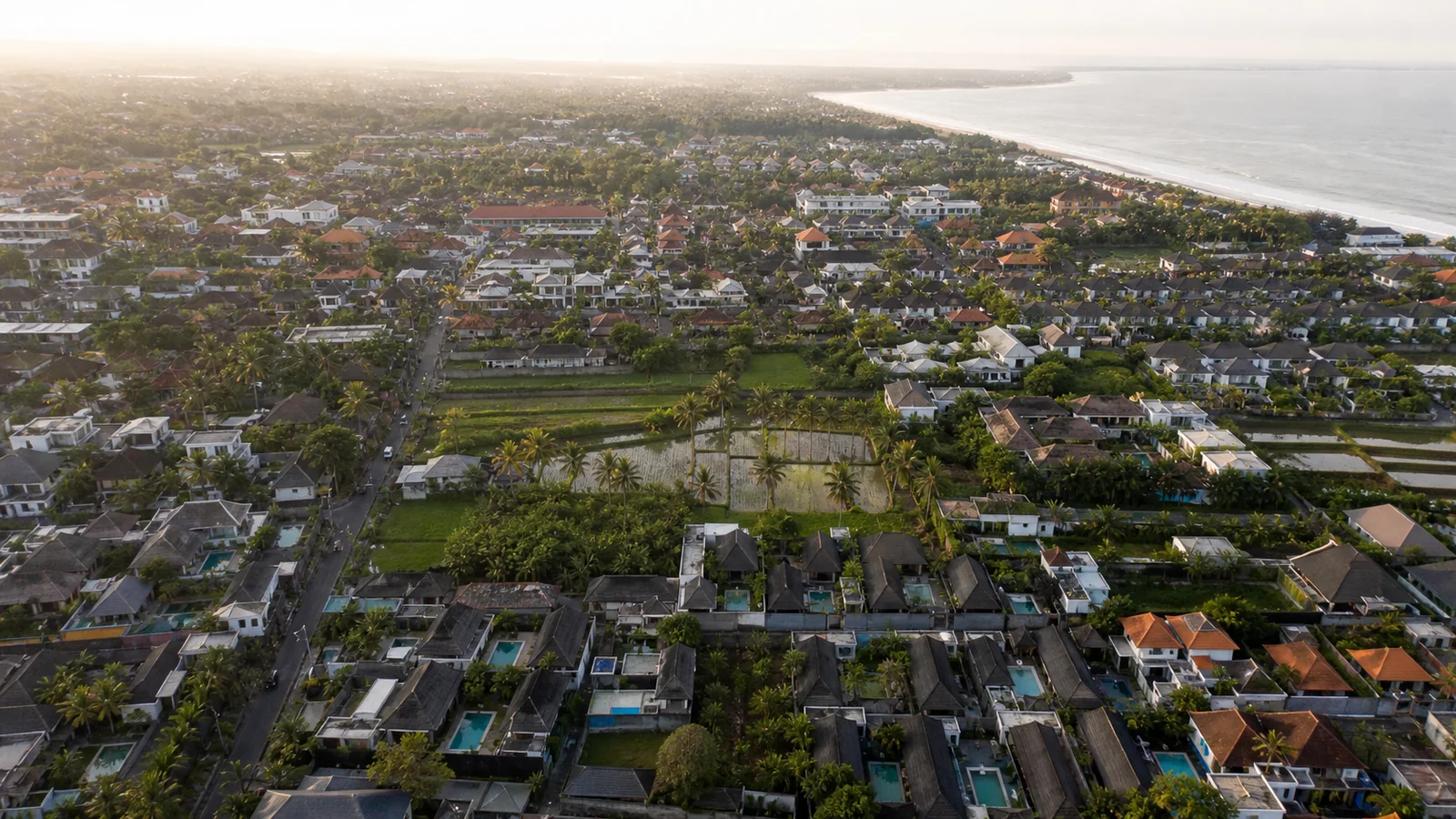 Dense villa and pool development across a Bali coastal district