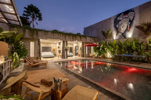 Concrete Serenity's courtyard and pool illuminated at dusk