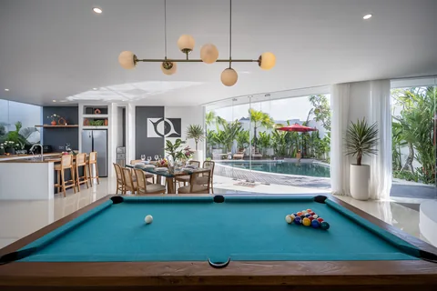 Villa Soluna's open games and dining room beside the pool
